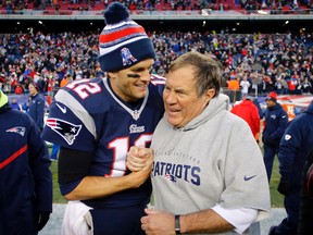 New England Patriots quarterback Tom Brady (12) and head coach Bill Belichick (R) are all smiles after clinching the AFC East title with a 41-13 win over the Miami Dolphins at Gillette Stadium in Foxborough, Mass., on Dec. 14, 2014. (WINSLOW TOWNSON/USA TODAY Sports)