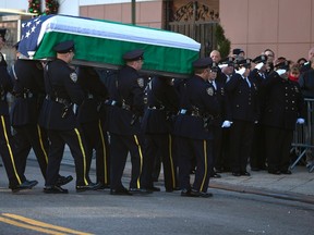 The casket of Rafael Ramos arrives at Christ Tabernacle Church carried by a New York Police Department honour guard in the Queens borough of New York Dec. 26, 2014. REUTERS/Carlo Allegri