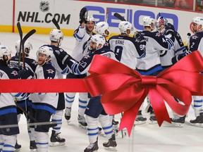 The Winnipeg Jets celebrate their 5-1 victory against the Chicago Blackhawks Dec. 23, 2014.