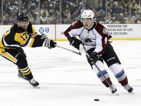 Colorado Avalanche center Matt Duchene (9) skates with the puck against pressure from Pittsburgh Penguins left wing Blake Comeau (17) during the first period at the CONSOL Energy Center on Dec 18, 2014 in Pittsburgh, PA, USA. (Charles LeClaire/USA TODAY Sports)