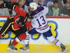 Oilers forward Steve Pinnizzotto tangles with a Flames player during pre-season action in Calgary in October. (Stuart Dryden, QMI Agency)