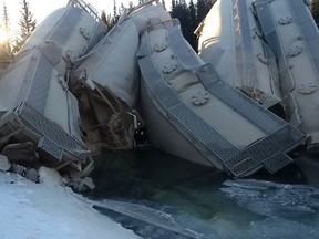 Fifteen CP Rail cars carrying grain and ingredients for cement left the tracks near Banff, early Friday, with some ending up in 40 Mile Creek, a tributary of the Bow River. Transportation Safety Board of Canada officials are at the scene just west of Banff near the 40 Mile Creek Bridge, which was destroyed in the accident. (TSB/QMI Agency)