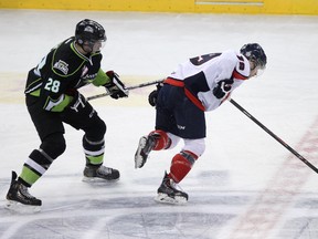 Edmonton defenceman Jesse Mills (28) poke checks Lethbridge forward Riley Sheen (19) as the Edmonton Oil Kings take on the Lethbridge Hurricanes during the third period of a WHL hockey game at Rexall Place in Edmonton, Alta., on Monday, Feb. 17, 2014. The Oil Kings won 12-0. Ian Kucerak/Edmonton Sun/QMI Agency