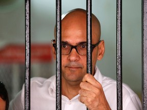Canadian teacher Neil Bantleman looks out from a holding cell to speak with supporters before the start of his trial at a South Jakarta court Dec. 23. Bantleman, along with Indonesian teaching assistant Ferdinand Tjiong, are on trial for alleged sexual assault at a Jakarta international school. (Darren Whiteside/Reuters)