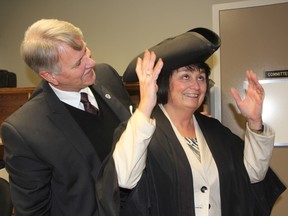 Newly-elected Lambton County Warden Bev MacDougall tries on the warden's traditional tricorn hat for the first time with help from St. Clair Township Mayor Steve Arnold. MacDougall, who previously served as deputy warden, defeated Arnold in a secret ballot vote to become the county's 156th warden Wednesday. BARBARA SIMPSON/THE OBSERVER/QMI AGENCY
