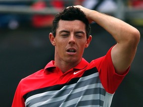World number one and defending champion Rory McIlroy of Northern Ireland reacts after finishing his fourth and final round of the Australian Open golf tournament at The Australian Golf Club in Sydney November 30, 2014. (REUTERS/David Gray)