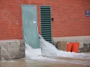 Water from a broken main forced its way through a door at Telus Field Saturday. Crews took hours to clean up the resulting mess. PHOTO SUBMITTED