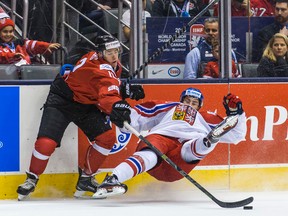 Switzerland's Jason Fuchs and Czech Republic's Lukáš Klok during the IIHF World Junior Championship at the Air Canada Centre on December 27, 2014. (Ernest Doroszuk/Toronto Sun/QMI Agency)