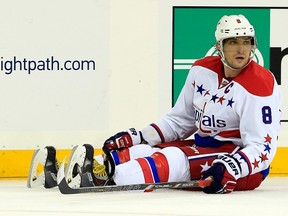 Alex Ovechkin of the Washington Capitals sits on the ice after being checked in the third period against the New York Rangers during a game at Madison Square Garden on December 23, 2014. (Alex Trautwig/Getty Images/AFP)