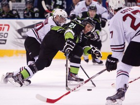 Edmonton Oil Kings' Tyler Robertson battles the Red Deer Rebels' Austin Adamson and Brett Cote during first period WHL action at Rexall Place, in Edmonton Alta., on Saturday Dec. 27, 2014. David Bloom/Edmonton Sun/QMI Agency