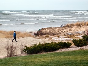 A resident walks along Ipperwash Beach (Postmedia Network file photo)