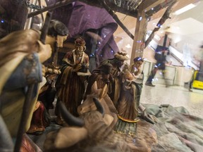 People walk past a nativity scene on display in the main lobby of the Ottawa Hospital General Campus on December 19, 2014. (Errol McGihon/QMI Agency)