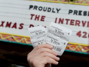 Tickets for the film "The Interview" is seen held up by theater manager Donald Melancon for the media at Crest Theater in Los Angeles, California December 24, 2014. (REUTERS/Kevork Djansezian)