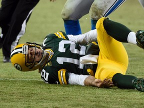 Packers quarterback Aaron Rodgers lies on the ground after an injury in the second quarter against the Lions at Lambeau Field in Green Bay, Wisc., on Sunday, Dec. 28, 2014. (Benny Sieu/USA TODAY Sports)