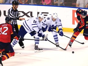Maple Leafs' Peter Holland and Dion Phaneuf chase down the puck as Panthers' Jonathan Huberdeau and Jimmy Hayes close in on Sunday night in Sunrise, Fla. (USA TODAY SPORTS/PHOTO)