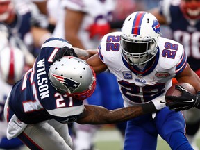 Bills running back Fred Jackson (right) runs the ball against Patriots strong safety Tavon Wilson (left) during second half NFL action at Gillette Stadium in Foxborough, Mass., on Sunday, Dec. 28, 2014. (Mark L. Baer/USA TODAY Sports)