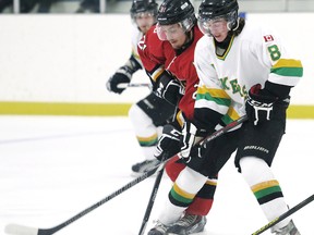 Wallaceburg Lakers' Jeff Brown (8) and Blenheim Blades' Hunter Burk battle for the puck in the first period Sunday at Blenheim Memorial Arena. Blades goalie Klinton Kenney made 22 saves in a 4-0 win, sending the Lakers to their 16th consecutive loss in the Great Lakes Junior 'C' Hockey League. (MARK MALONE/The Daily News)