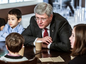 Prime Minister Stephen Harper interacts with children earlier this year at an event in B.C. Harper's tax cuts will save families some money in 2015. (Carmine Marinelli/QMI Agency file photo)