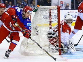 Russia's Anatoli Golyshev rounds the Denmark net during World Junior Championship play at the Air Canada Centre in Toronto Friday December 26, 2014. (Dave Abel/Toronto Sun/QMI Agency)