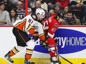 Anaheim Ducks forward Dany Heatley battles for the puck with Ottawa Senators defenceman Erik Karlsson during NHL action at the Canadian Tire Centre in Ottawa Friday December 19, 2014. (Errol McGihon/Ottawa Sun/QMI Agency)