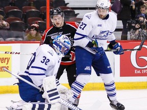 Ottawa 67's Dante Salituro and  Mississauga Steelheads Nick Zottl eye the rebound after netminder Spencer Martin makes a save during OHL hockey action at the Canadian Tire Centre on Tuesday March 04,2014. Errol McGihon/Ottawa Sun/QMI Agency
