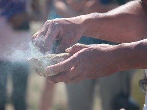 A First Nation elder prepares a smudging ceremony (Postmedia file photo)