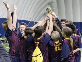 Members of the Kingston United under-14 boys team celebrate after winning a championship at the second annual Kingston Cup soccer tournament at the Kingston 1000 Islands Sportsplex on Monday. (Supplied photo)