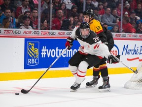 Lawson Crouse of the Kingston Frontenacs battles for the puck against Kai Wissmann in the third period of the game between  Canada and Germany during the 2015 IIHF World Junior Championship on Saturday at the Bell Centre in Montreal. (Johany Jutras/QMI Agency)