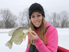 Ashley Rae holds a black crappie, which can be feisty and plentiful during ice fishing season. (Supplied photo)