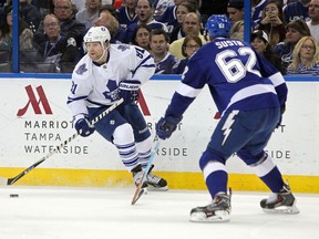 Toronto Maple Leafs right wing Phil Kessel (81) skates with the puck as Tampa Bay Lightning defenceman Andrej Sustr (62) defends during the first period at Amalie Arena in Tampa Dec 29, 2014. (Kim Klement-USA TODAY Sports)