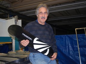Immortal Skateboards owner Paul Hallett holds one of his innovative skate decks in his factory on Edward St. in St. Thomas on Monday. The boards are made of carbon composite material and are said to last five times longer than conventional plywood decks. (Ben Forrest/Times-Journal)