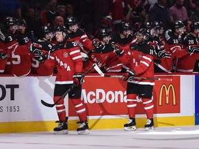 Canada's Sam Reinhart and Anthony Duclair are congratulated by their teammates after a goal during the 2015 IIHF World Junior Championship at the Bell Center on Dec. 29, 2014. (MICHEL DESBIENS/QMI AGENCY)