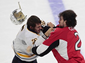 Senators defenceman Jared Cowen and Sabres forward Patrick Kaleta fight during first period NHL action in Ottawa on Monday, Dec. 29, 2014. (Tony Caldwell/QMI Agency)