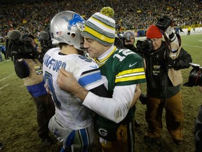 Quarterbacks Matthew Stafford #9 of the Detroit Lions and Aaron Rodgers #12 of the Green Bay Packers hug after the Packers defeated the Lions 30-20 during the NFL game at Lambeau Field on December 28, 2014 in Green Bay, Wisconsin. (Mike McGinnis/Getty Images/AFP)