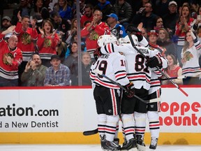 Chicago Blackhawks fans join the celebration as Patrick Kane of the Chicago Blackhawks scored against the Colorado Avalanche to tie the score 2-2 in the first period at Pepsi Center on December 27, 2014. (Doug Pensinger/Getty Images/AFP)