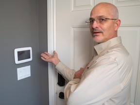 Bob Hoevenaars runs the home and office security company Alarmtech on Huron St. A control panel for an alarm system by Honeywell, left, can accept verbal commands. (Mike Hensen, The London Free Press)