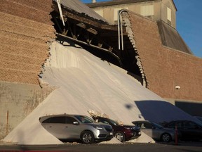 A partially collapsed wall at the Morton Salt facility gave way to tons of salt being dumped onto parked cars at an adjacent car dealership in Chicago, Illinois, December 30, 2014. No injuries were reported in the incident but several cars were covered in salt. REUTERS/Andrew Nelles