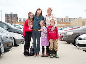 Shelley Funk stands with her mother, Marg Boss, and children Isabel, Emilia and Hayden. Funk, who?s father died at Victoria Hospital after complications from congestive heart failure on Dec. 20, has set up a fund to help others pay for parking at area hospitals. (CRAIG GLOVER/The London Free Press)
