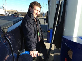 Justin Rose fuels his pickup truck on Tuesday morning at the Ultramar station at the corner of Sir John A. Macdonald and John Counter boulevards, where the pump price was 92.6 cents a litre for regular. (Paul Schliesmann/The Whig-Standard)