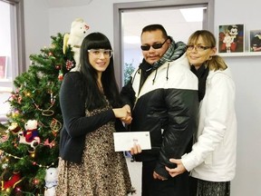Kirby (centre) and Marie Fontaine (right) visited by The Dream Factory office to donate $100,016 on Monday, Dec. 29, 2014.  The Dream Factory's communications/fundraising co-ordinator, Cindy Titus (left) accepted the cheque.