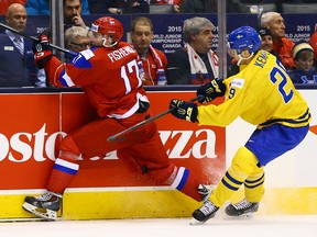 Russia's Ivan Fishenko is hit into the boards during a game at the 2015 World Junior Hockey Championships at the Air Canada Centre on December 29, 2014. (Dave Abel/Toronto Sun/QMI Agency)