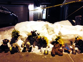 An impromptu memorial is seen at the site of a mass homicide hear 83 Street and 180 Avenue in Edmonton, Alta., on Tuesday, Dec. 30, 2014. Nine people in total died at three separate locations. Kevin Maimann/Edmonton Sun/QMI Agency