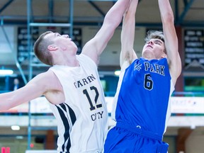 Oak Park's Wyatt Tait (right) shoots the ball against the guarding of Garden City's Jacob Penner during the 2014 Wesmen Classic high school boys final, Tuesday, Dec. 30, 2014. Kelly Morton Photography