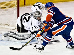 Edmonton's David Perron (57) scores the winner on Los Angeles' goalie Jonathan Quick (32) during the shootout of the Edmonton Oilers' NHL hockey game against the Los Angeles Kings at Rexall Place in Edmonton, Alta., on Tuesday, Dec. 30, 2014. The Oilers won 3-2. Codie McLachlan/Edmonton Sun/QMI Agency