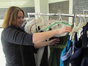 Debbie Anderson, of the Cinderella Story of Sarnia-Lambton, sorts through dresses. Hardly-worn and cleaned prom dresses can be dropped off this Friday at The Painted Cat during January's First Friday festivities. (File photo)