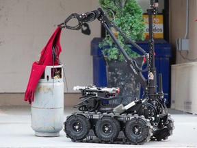 Police used a remote-controlled bomb disposal robot to examine a suspicious package left outside the front door of the apartment building at 583 Mornington Ave. in London Wednesday. The propane tank with wires dangling from it was determined to be a hoax and police removed the items without incident. (DEREK RUTTAN, The London Free Press)