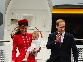 Britain's Prince William (R) and his wife Catherine, carrying baby Prince George, wave upon their arrival at the international airport in Wellington on April 7, 2014.  William, Kate and their son Prince George went on a three-week tour of New Zealand and Australia.  (AFP PHOTO)