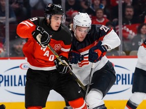 Robby Fabbri #29 of Team Canada and Hudson Fasching #22 of Team United States check one another during the 2015 IIHF World Junior Hockey Championship game at the Bell Centre on December 31, 2014 in Montreal, Quebec, Canada. (Minas Panagiotakis/Getty Images/AFP)