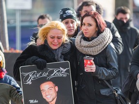 Gloria Da Luz (left), mother of murder victim Mike Pimentel and Carina Nunes, the victim's sister-in-law, on their way to a presser regarding his murder at the corner of Hanna Ave. and Liberty St. in Toronto December 31, 2014. (ERNEST DOROSZUK/Toronto Sun)