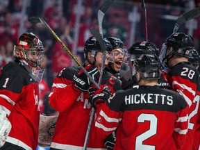 Canadian goaltender Eric Comrie, captain Curtis Lazar, Madison Bowey, Joe Hicketts Lawson Crouse celebrate their win over the U.S. at the 2015 World Junior Championship on December 31, 2014 at the Bell Centre in Montreal. (JOHANY JUTRAS/QMI Agency)